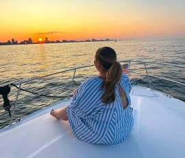Guest relaxing on the bow during a Chicago sunset cruise on Lake Michigan.
